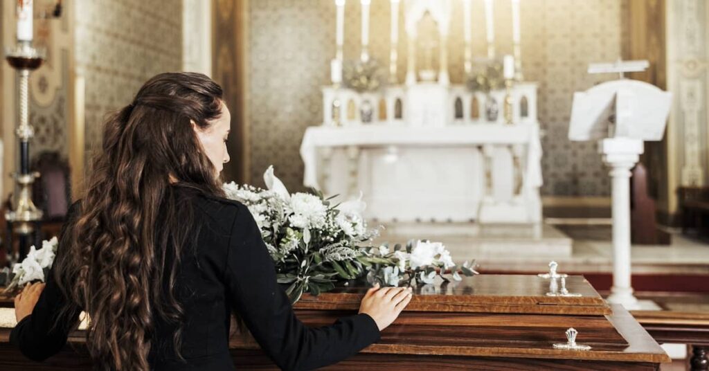 Female mourner at a funeral following the wrongful death of a loved one | Burg Simpson