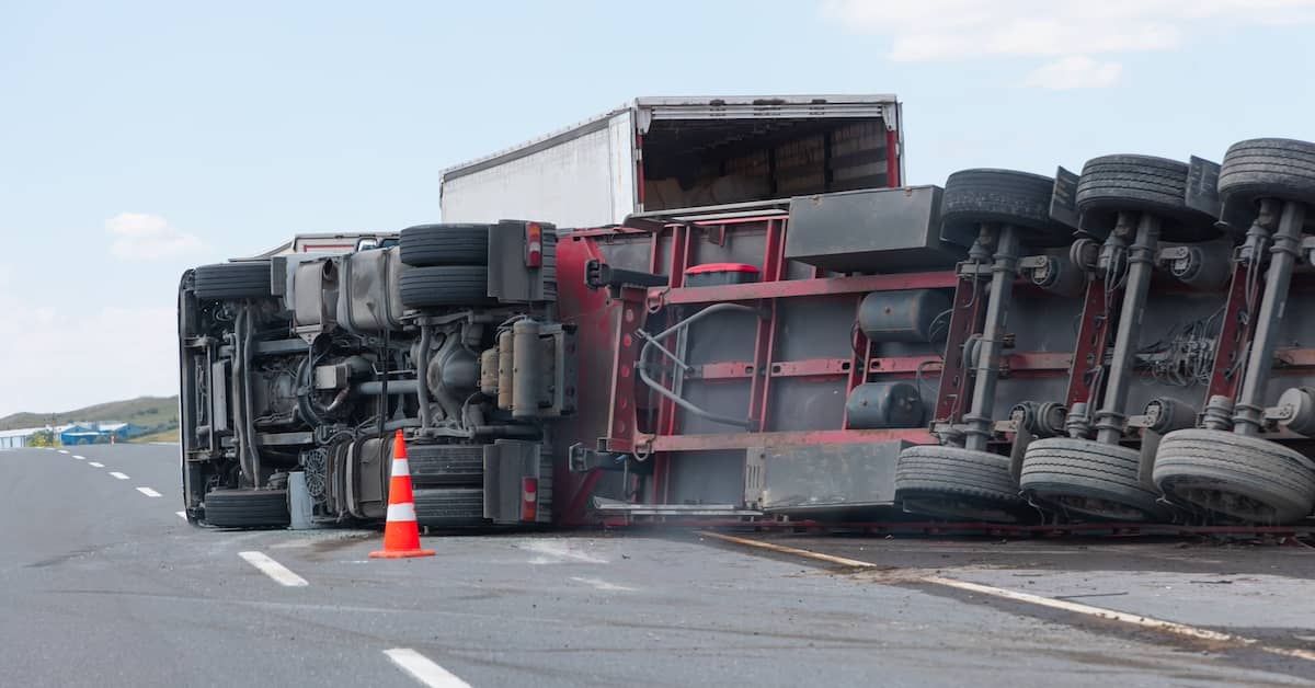 Semi-truck rolled over on its side after an accident | Burg Simpson