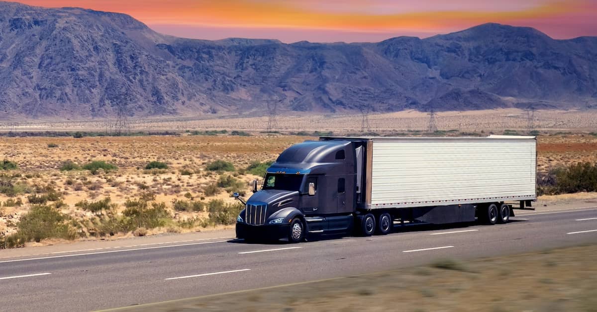 18-wheeler traveling on desert highway outside of Phoenix | Burg Simpson